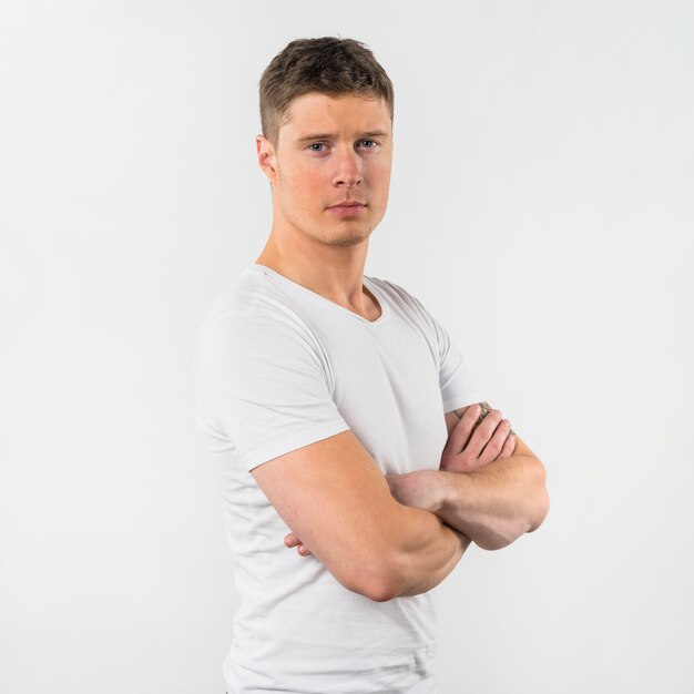Portrait of a young man with arms crossed isolated on white background