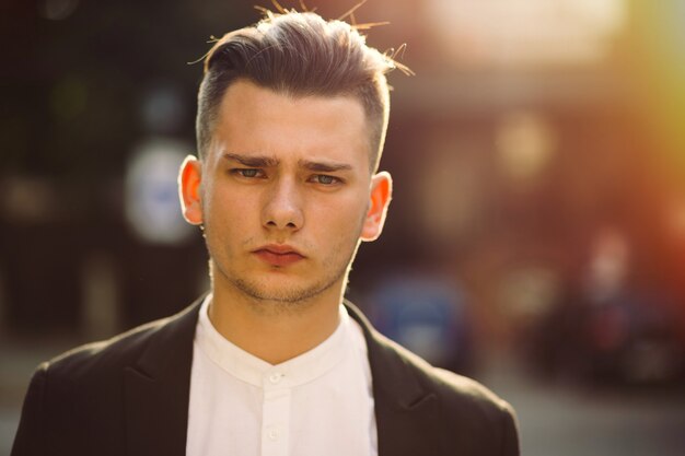 Portrait of young man with a backpack on his back