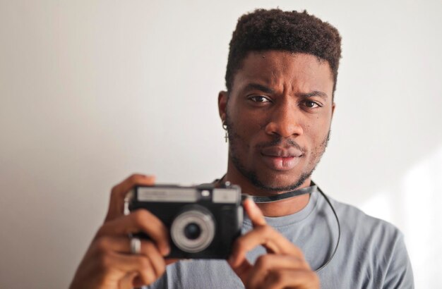 портрет молодого человека с фотоаппаратом в руке