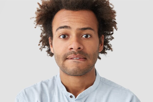 Portrait of young man with curly hair wearing shirt