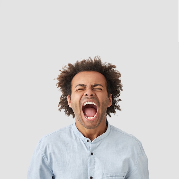 Free photo portrait of young man with curly hair wearing shirt