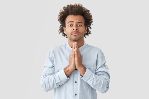 Portrait of young man with curly hair wearing shirt