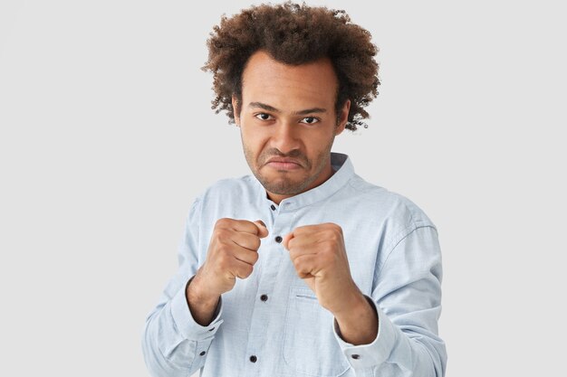 Portrait of young man with curly hair wearing shirt