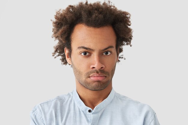 Portrait of young man with curly hair wearing shirt