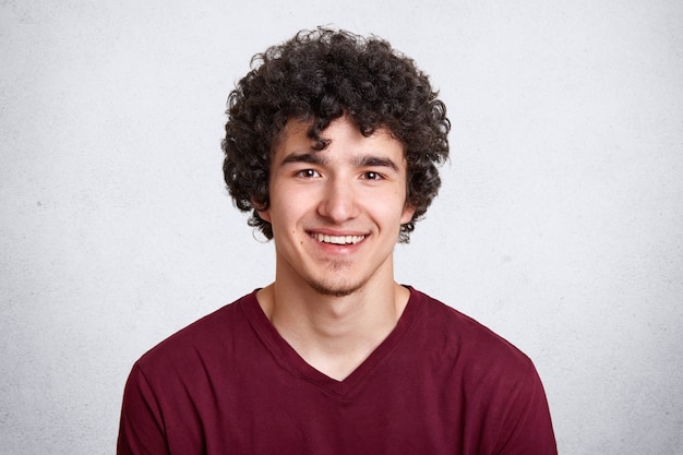 Free photo portrait of young man with dark curly hair