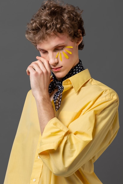 Free photo portrait young man with make up posing