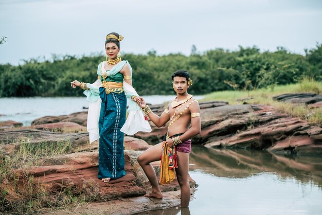 Portrait of Young man and woman wearing beautiful traditional costume pose in nature in Thailand