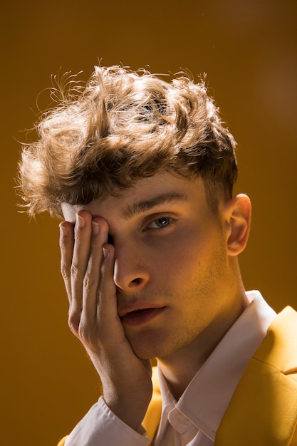 Free photo portrait of a young man in a yellow scene