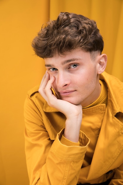 Free photo portrait of a young man in a yellow scene