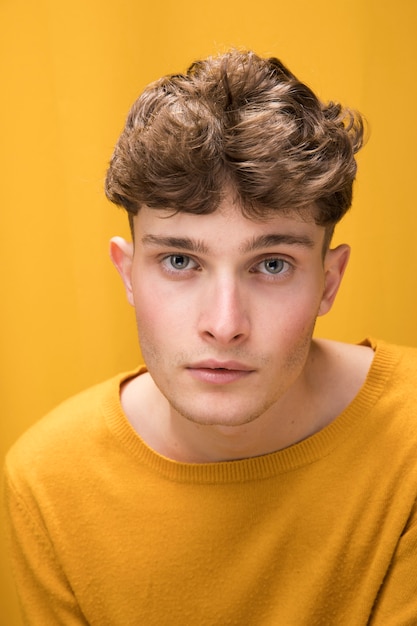 Free photo portrait of a young man in a yellow scene