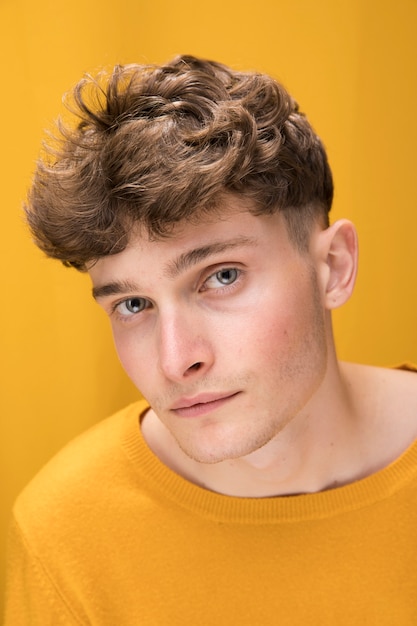 Free photo portrait of a young man in a yellow scene