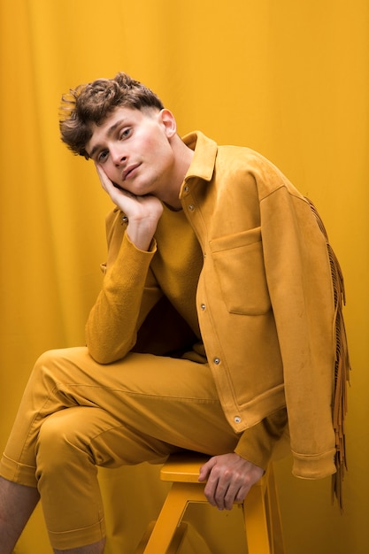 Free photo portrait of a young man in a yellow scene