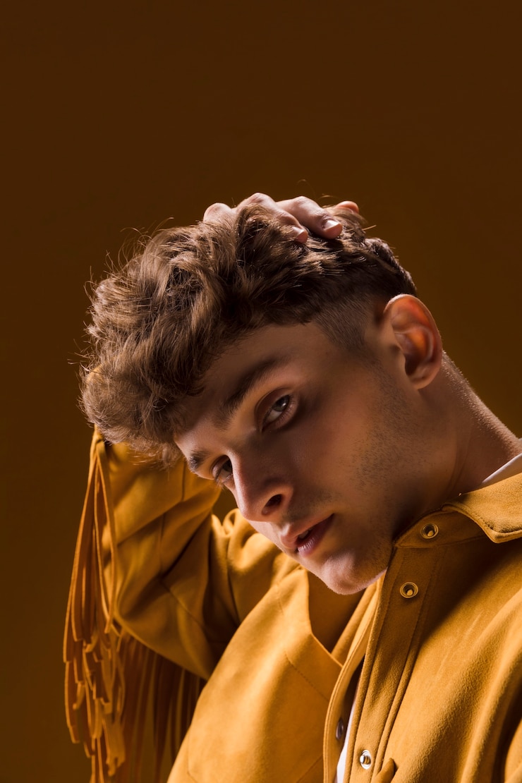 Free Photo portrait of young man in a yellow scene