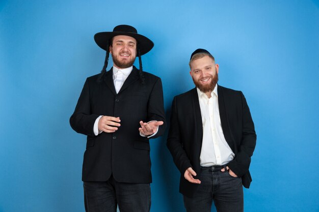 Portrait of a young orthodox jewish men isolated on blue studio
