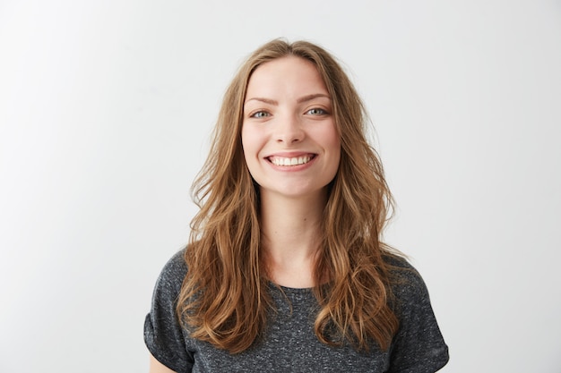 Portrait of young pretty cheerful girl smiling .