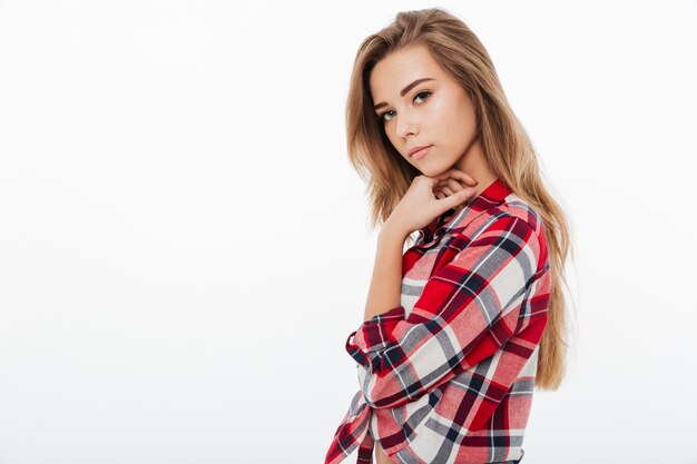 Portrait of a young pretty girl in plaid shirt