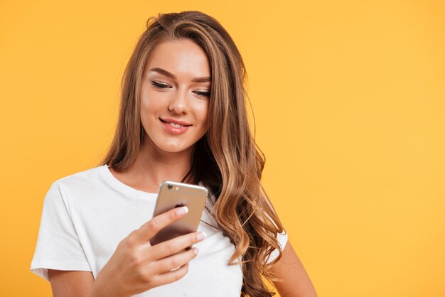 Portrait of a young pretty girl using mobile phone