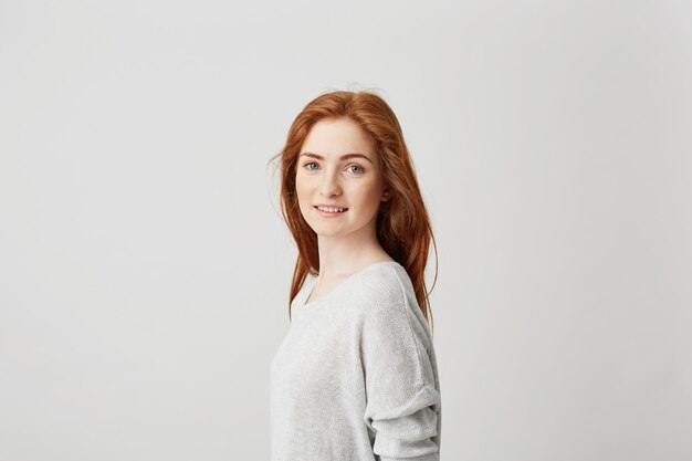 Portrait of young pretty girl with beautiful foxy hair smiling .