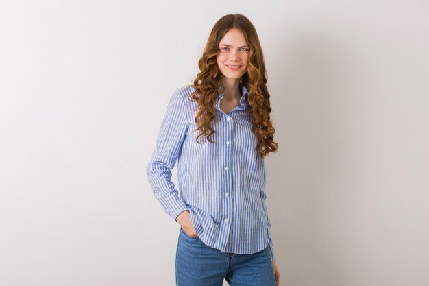 Portrait of young pretty natural woman posing in blue striped cotton shirt against white