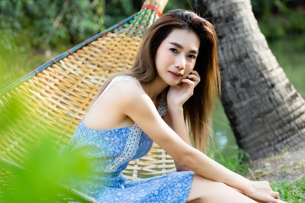 Portrait young pretty woman sitting in hammock