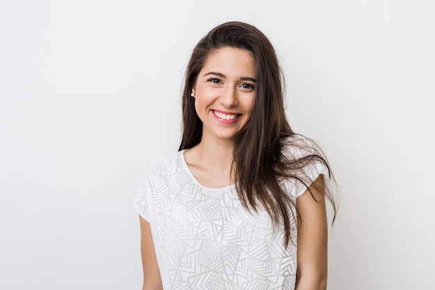 Portrait of young pretty woman smiling in white t-shirt , happy, positive mood, isolated, sincere smile, long hair