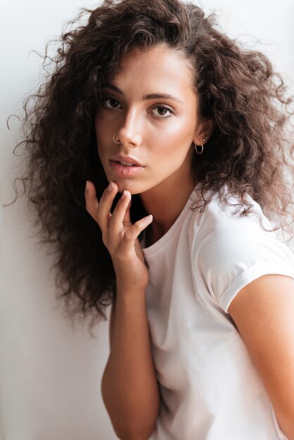 Portrait of a young pretty woman with long curly hair