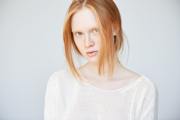 Portrait of young red-haired woman posing