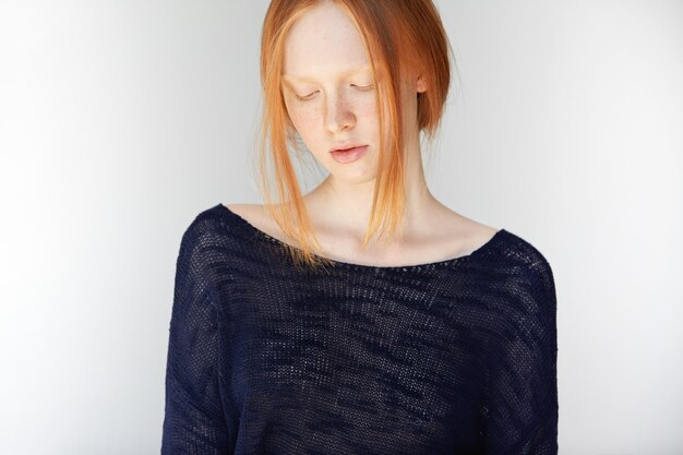 Portrait of young red-haired woman posing