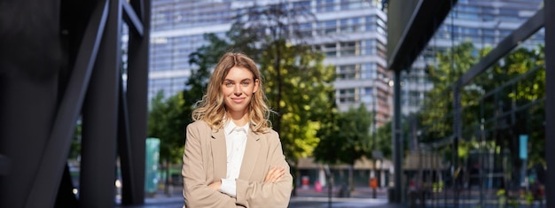 Free photo portrait of young saleswoman confident businesswoman in suit cross arms on chest standing in power