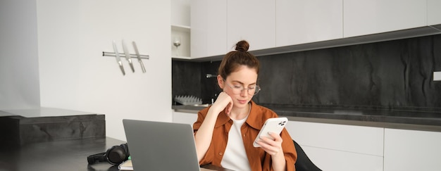 Portrait of young selfemployed woman working on start up from home freelancer programmer with