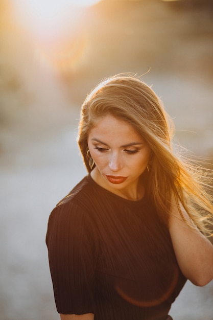 Portrait of a young sensual woman on a sunset