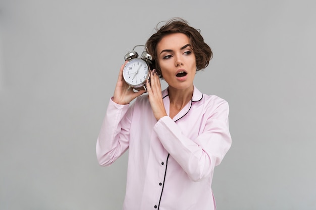 Portrait of a young shocked woman in pajamas