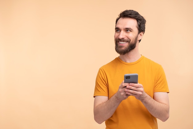 Portrait of young smiley man holding smartphone
