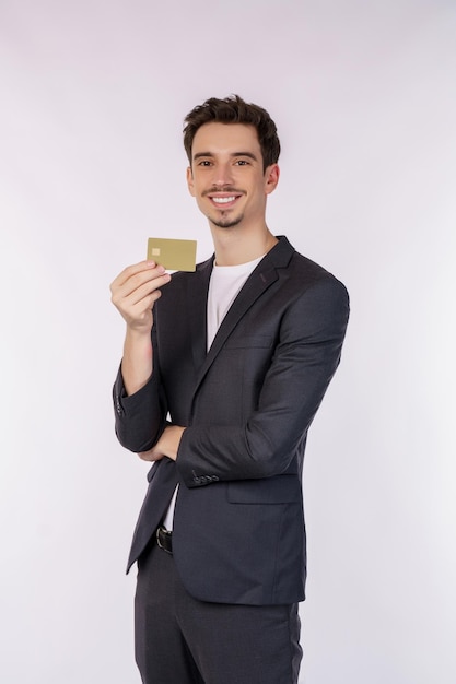 Портрет молодого улыбающегося красивого бизнесмена с кредитной картой на белом фоне