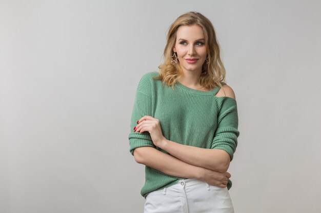 Portrait of young smiling happy attractive woman, positive, confident, elegant, casual style, green sweater, model posing on white studio background, isolated, looking in camera