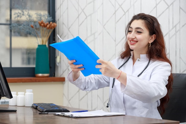 Portrait of young smiling health care worker holding analysis