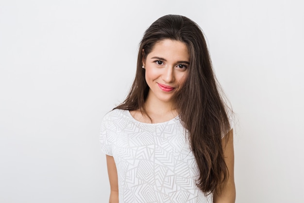 Portrait of young smiling natural looking woman in white blouse, long brown hair, , 