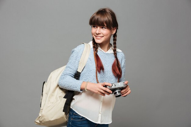 Portrait of a young smiling schoolgirl with backpack
