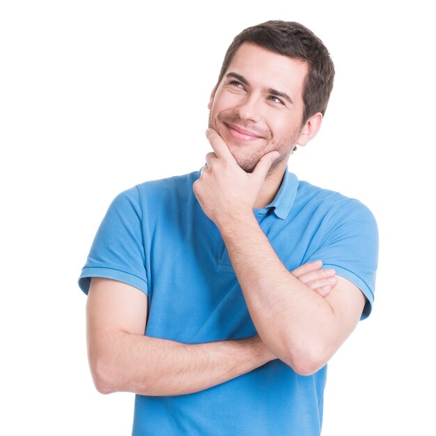 Portrait of the young smiling  thinking man looks up in casuals .