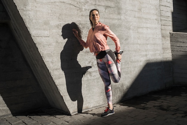 Portrait of young stretching outdoor