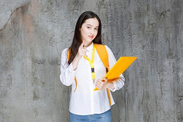 Portrait of young student looking at notes on book. High quality photo