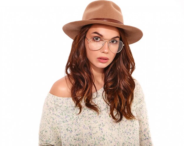 Portrait of young stylish girl model in casual summer clothes in brown hat with natural makeup in glasses isolated.