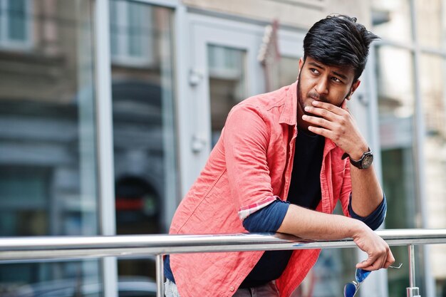 Portrait of young stylish indian man model pose in street