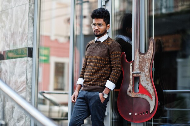 Portrait of young stylish indian man model pose in street