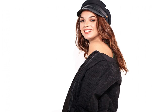 Portrait of young stylish laughing model in black casual summer clothes in cap with natural makeup on white