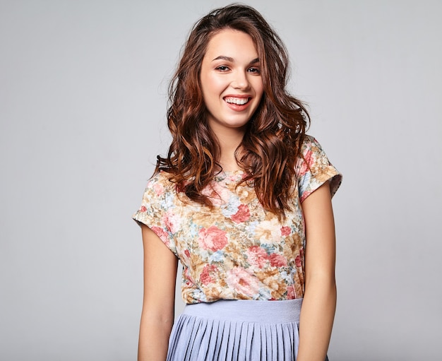 Portrait of young stylish laughing model in colorful casual summer clothes with natural makeup