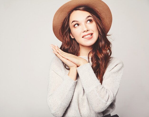 Portrait of young stylish  model in gray casual summer clothes in brown hat