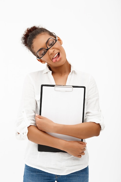 Portrait of young successful african business lady over white wall