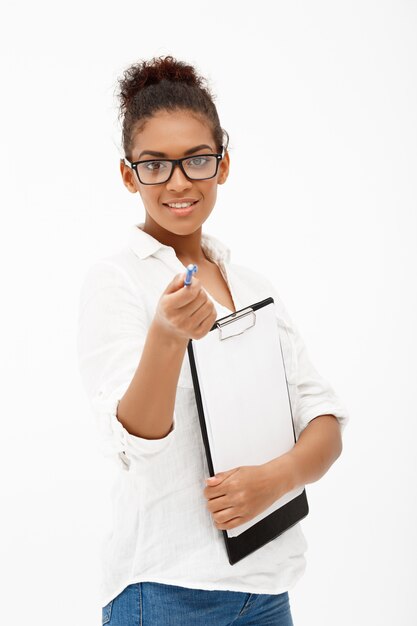 Portrait of young successful african business lady over white wall