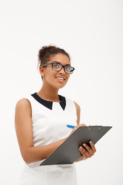 Portrait of young successful african business lady on white